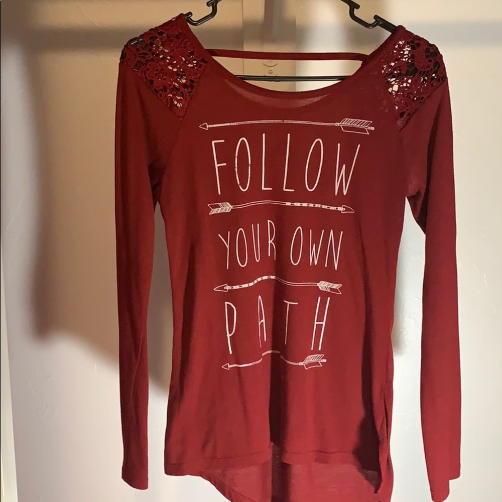 Red long sleeve shirt with lace on the sleeves.